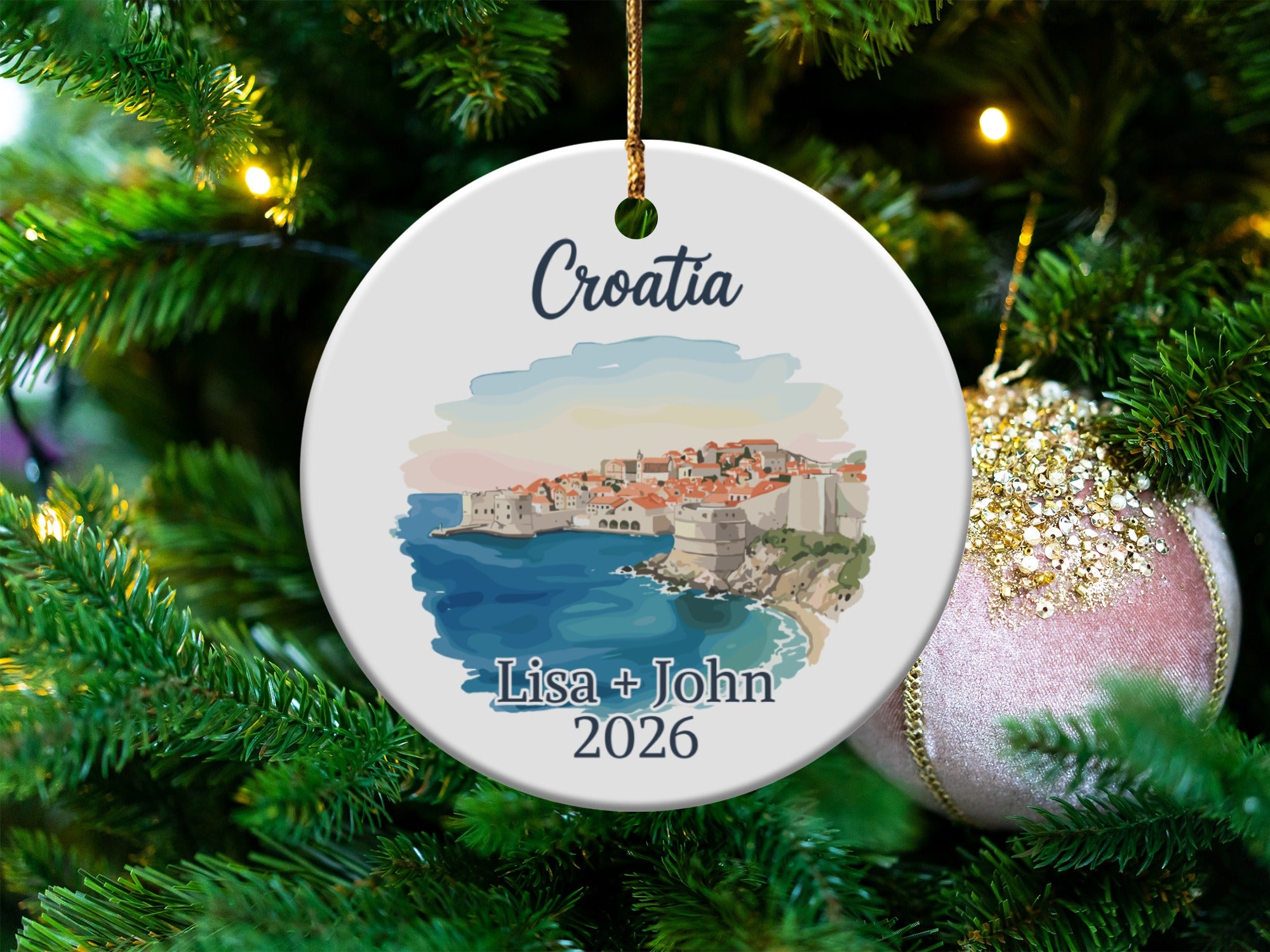 Round ornament with Dubrovnik, Croatia illustration, and "Lisa + John 2026" text.
