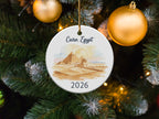Cairo, Egypt 2026 ornament with pyramids and Sphinx, against Christmas tree.