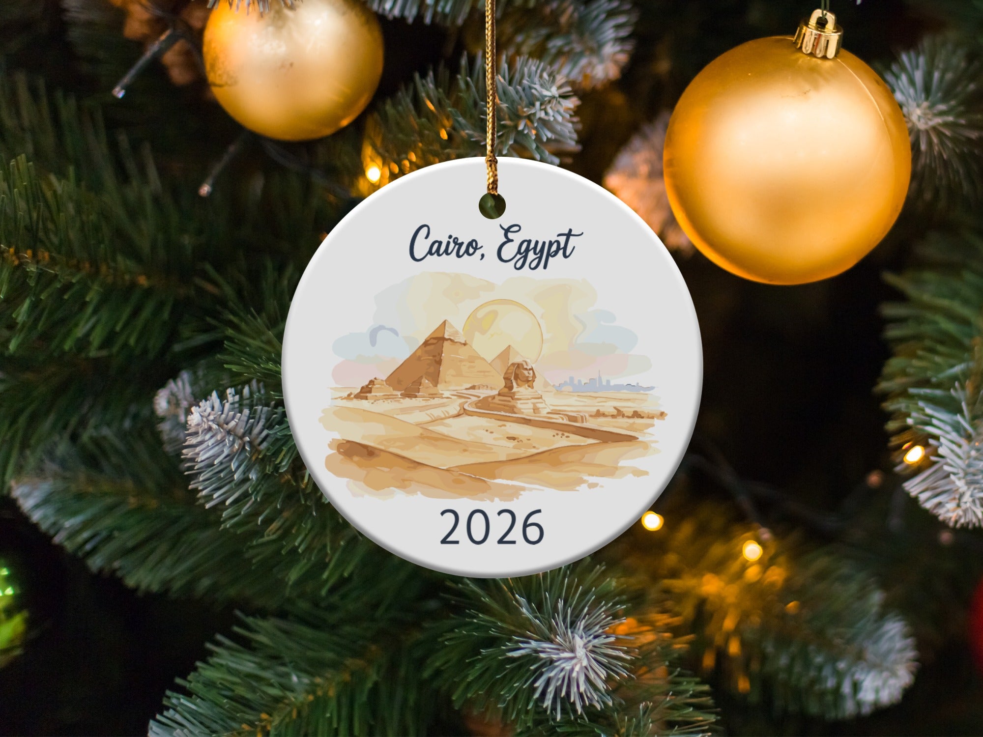 Cairo, Egypt 2026 ornament with pyramids and Sphinx, against Christmas tree.