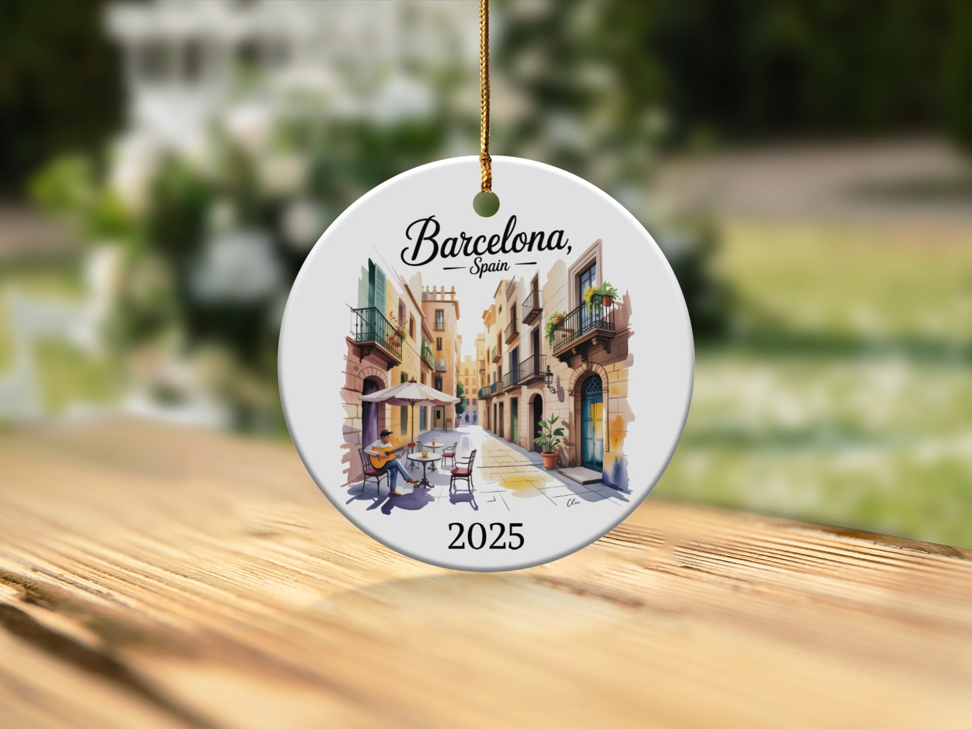 Round ceramic ornament featuring Barcelona street scene and year 2025.