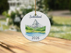 Round ornament with Matterhorn, lake, and "Switzerland 2026" text.