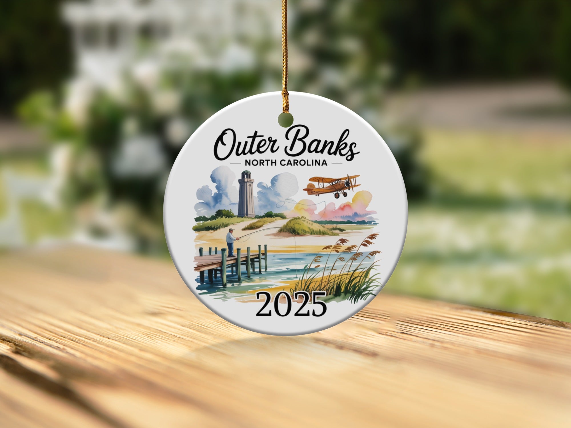 Outer Banks North Carolina 2025 ornament with lighthouse and biplane.