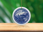 Round ornament with blue and white Kyoto Japan design on display table.