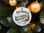 San Diego ornament with personalized names and date hangs on a Christmas tree.