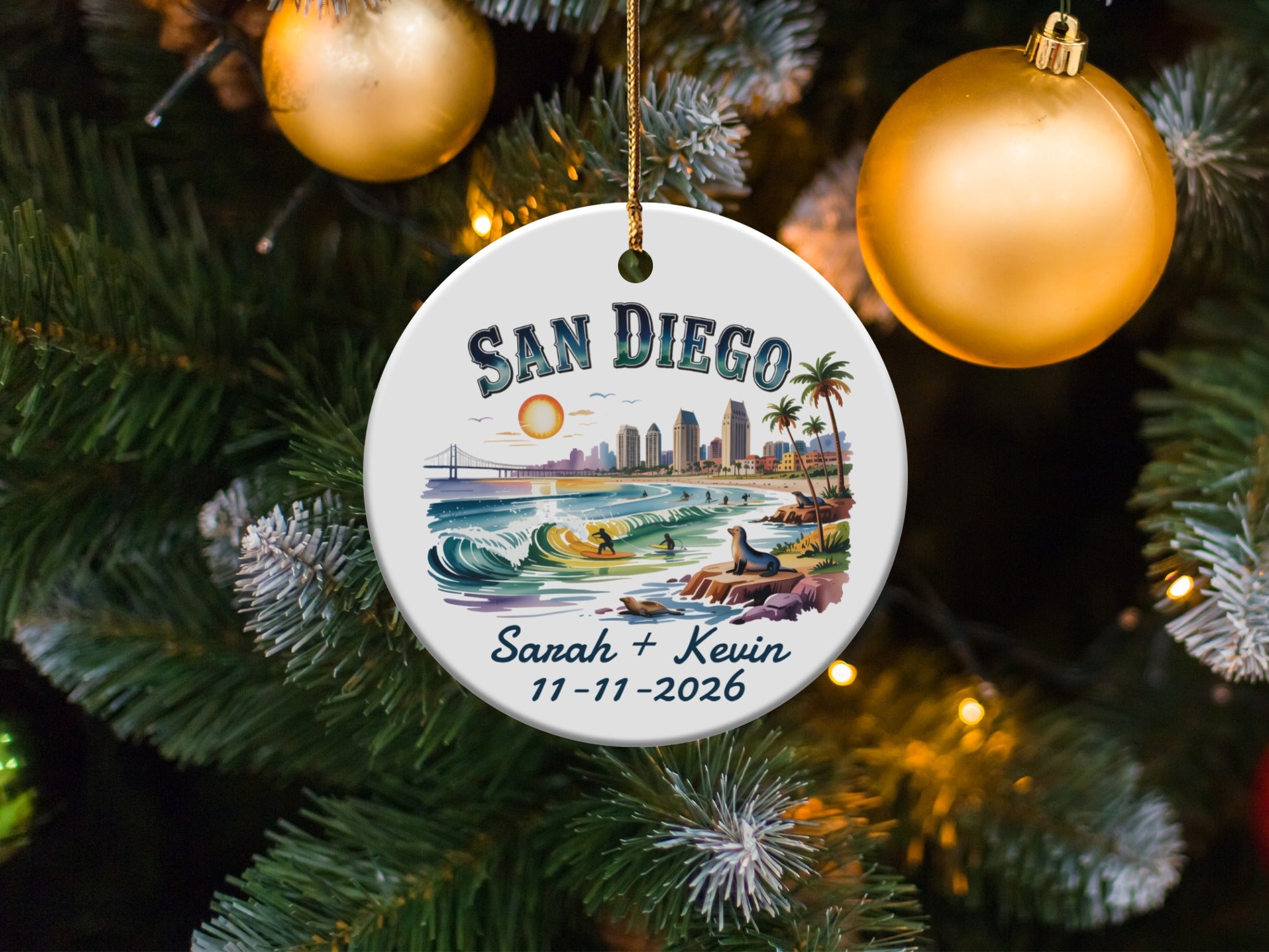 San Diego ornament with personalized names and date hangs on a Christmas tree.