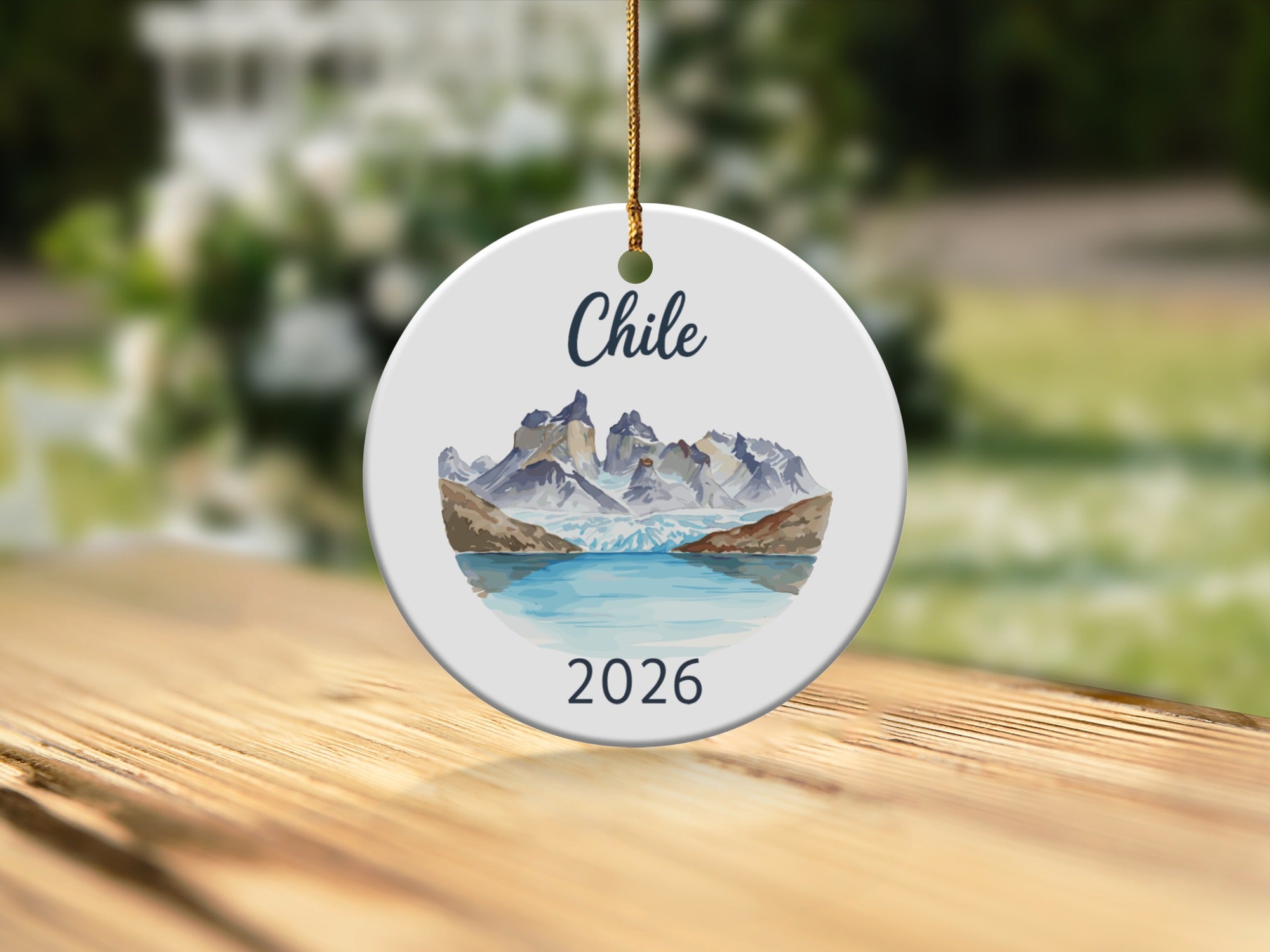 Round ceramic ornament featuring a Chilean mountain landscape and the year 2026.