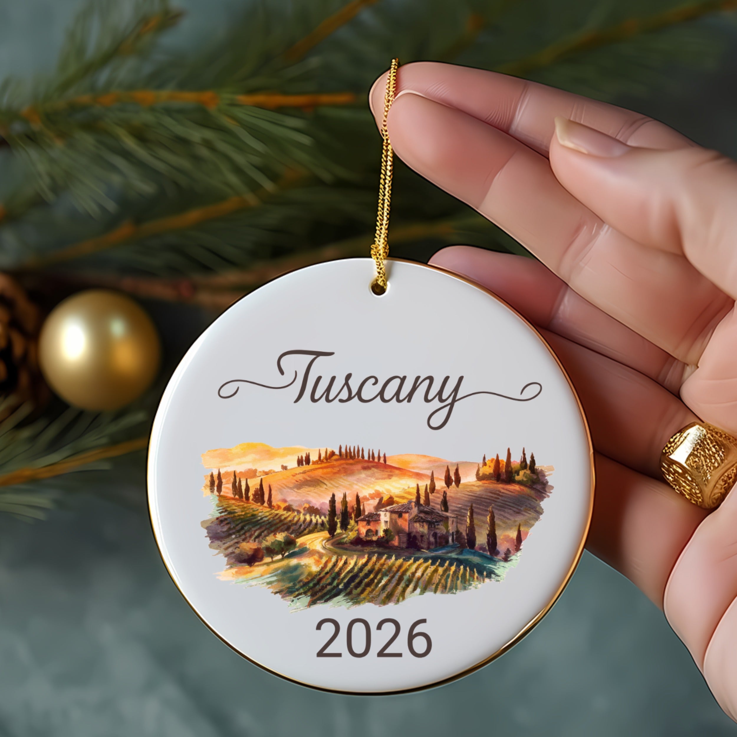 Round ornament with "Tuscany 2026" and watercolor landscape.