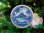 Round ornament with Bora Bora scene, palm trees, overwater bungalows, and mountains.