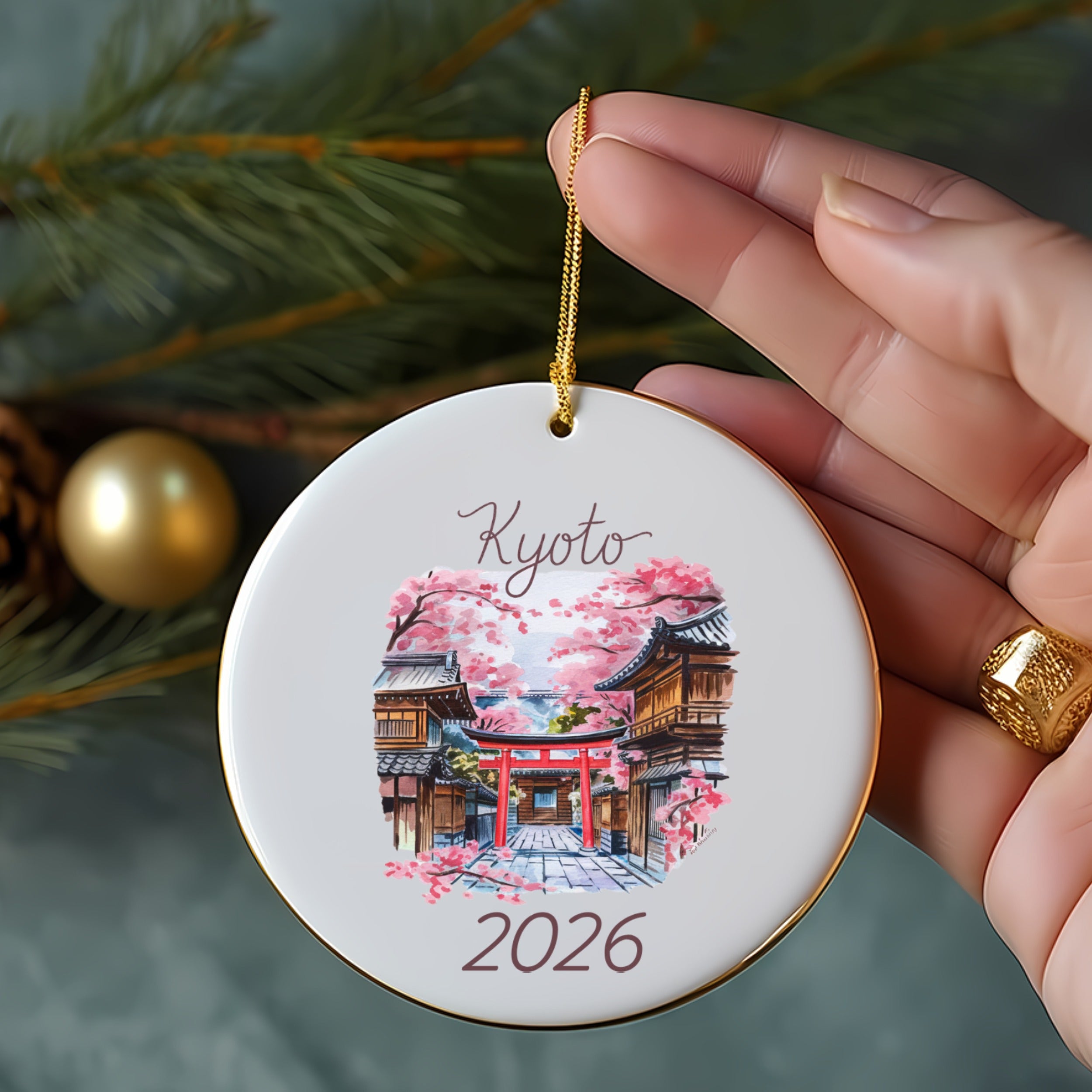 Round ornament with Kyoto temple and cherry blossoms, dated 2026.
