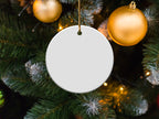 Blank white round ornament on Christmas tree with golden ornaments.