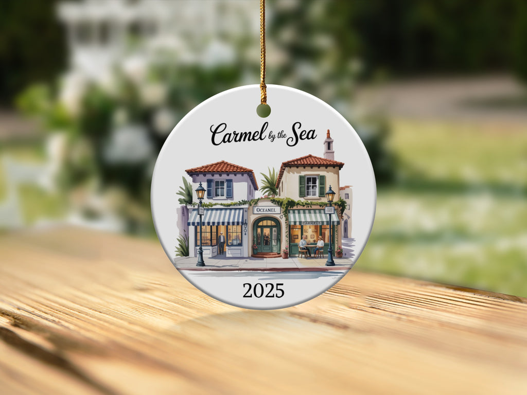 Round ceramic ornament with watercolor painting of Carmel by the Sea shops.