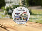 Round ceramic ornament with watercolor painting of Carmel by the Sea shops.