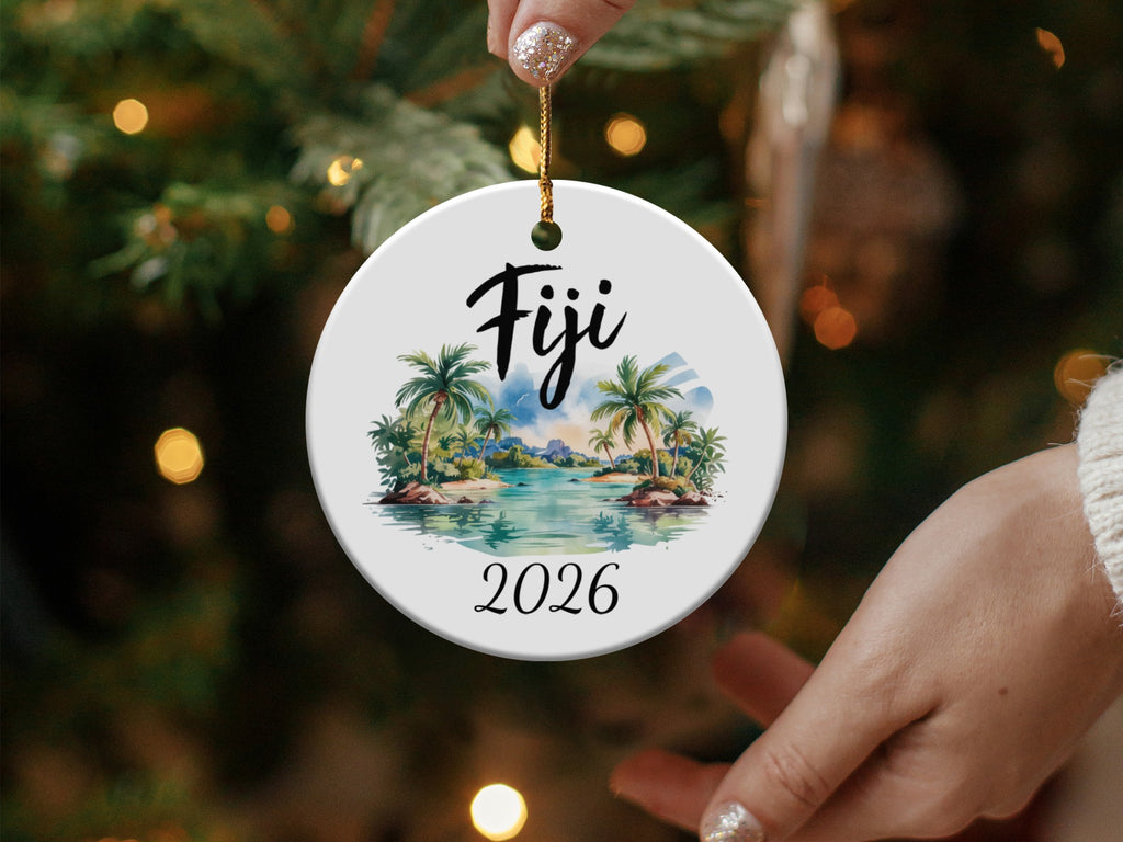 Round ornament with "Fiji 2026" and palm tree beach scene.