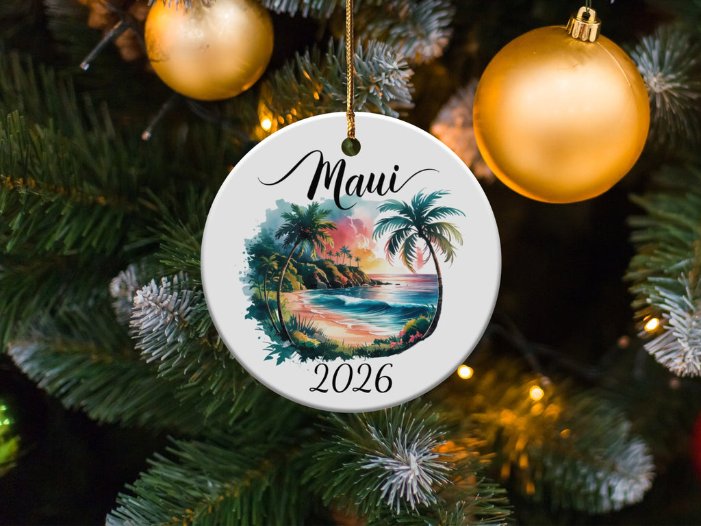 Round ceramic ornament depicting a Hawaiian beach scene with "Maui 2026" text.