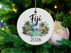 Round ceramic ornament with "Fiji 2026" and a tropical beach scene.