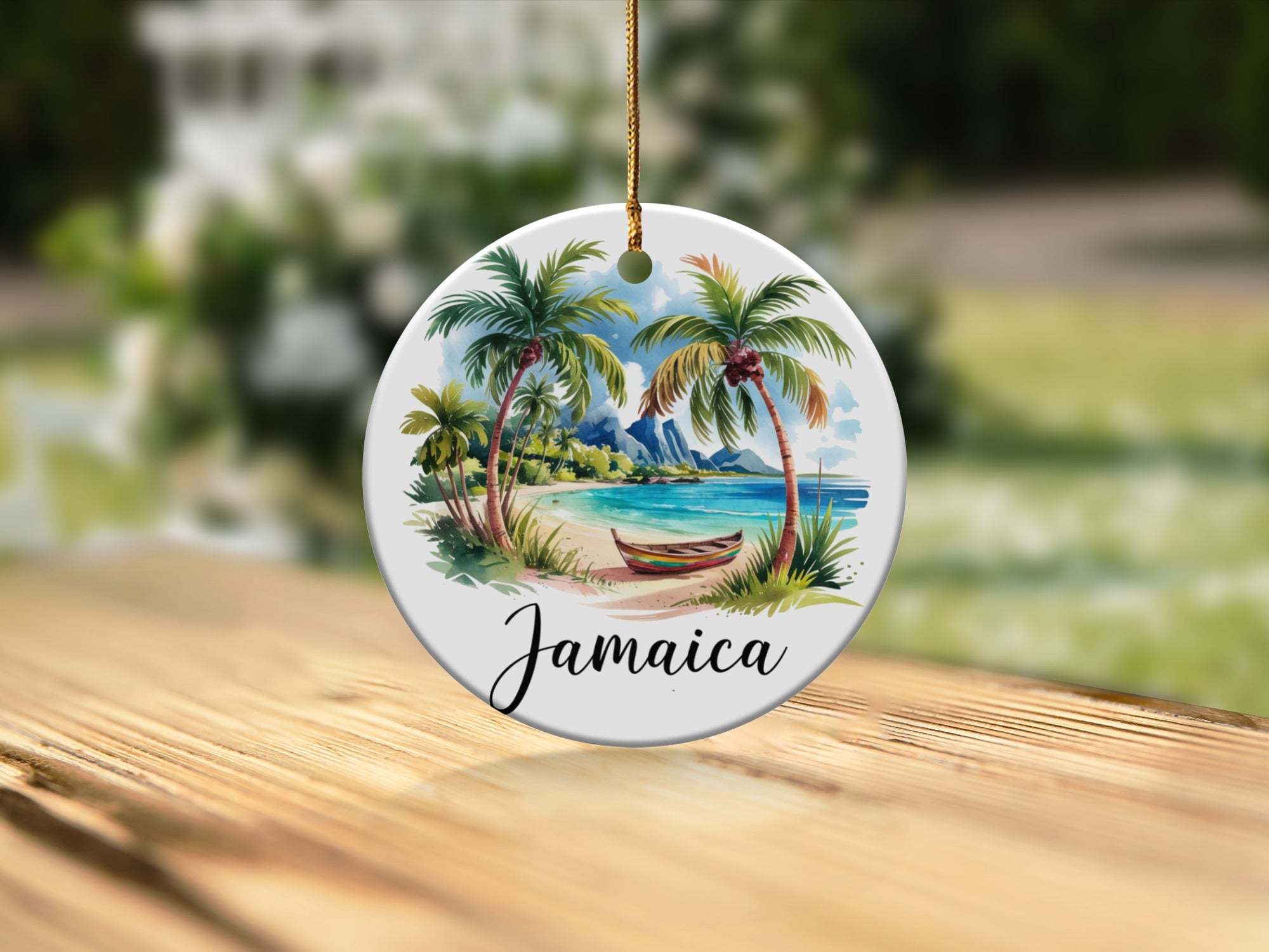 Round ceramic ornament with "Jamaica" text and a tropical beach scene.