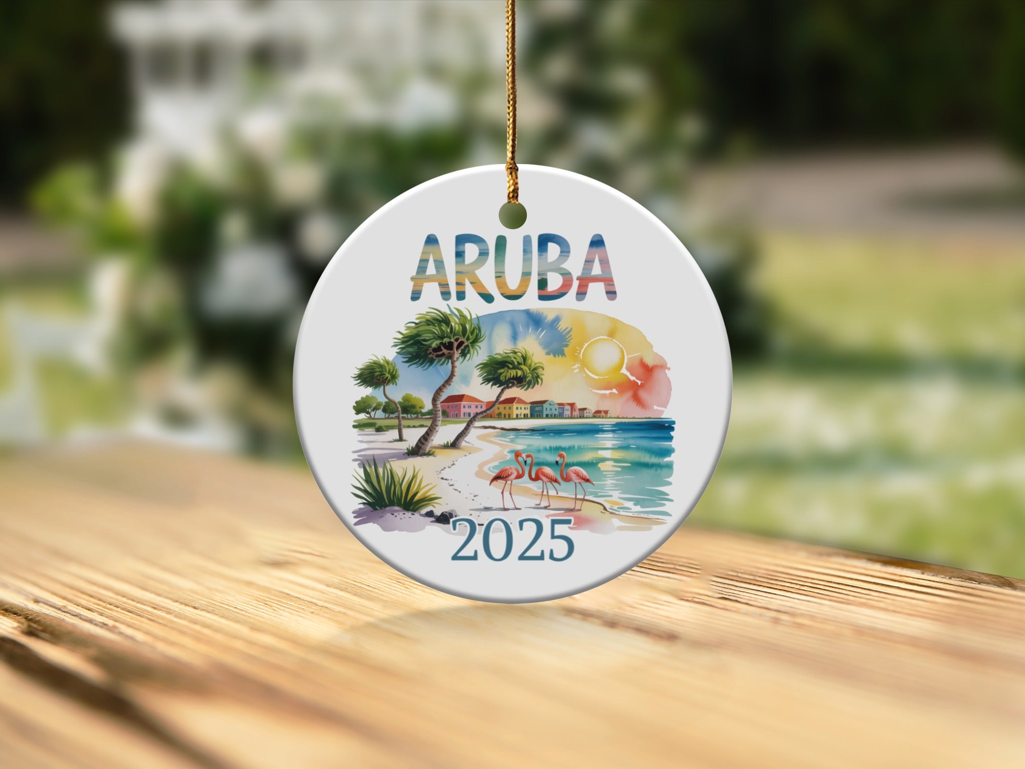 Aruba 2025 ornament with flamingos and palm trees on a beach.