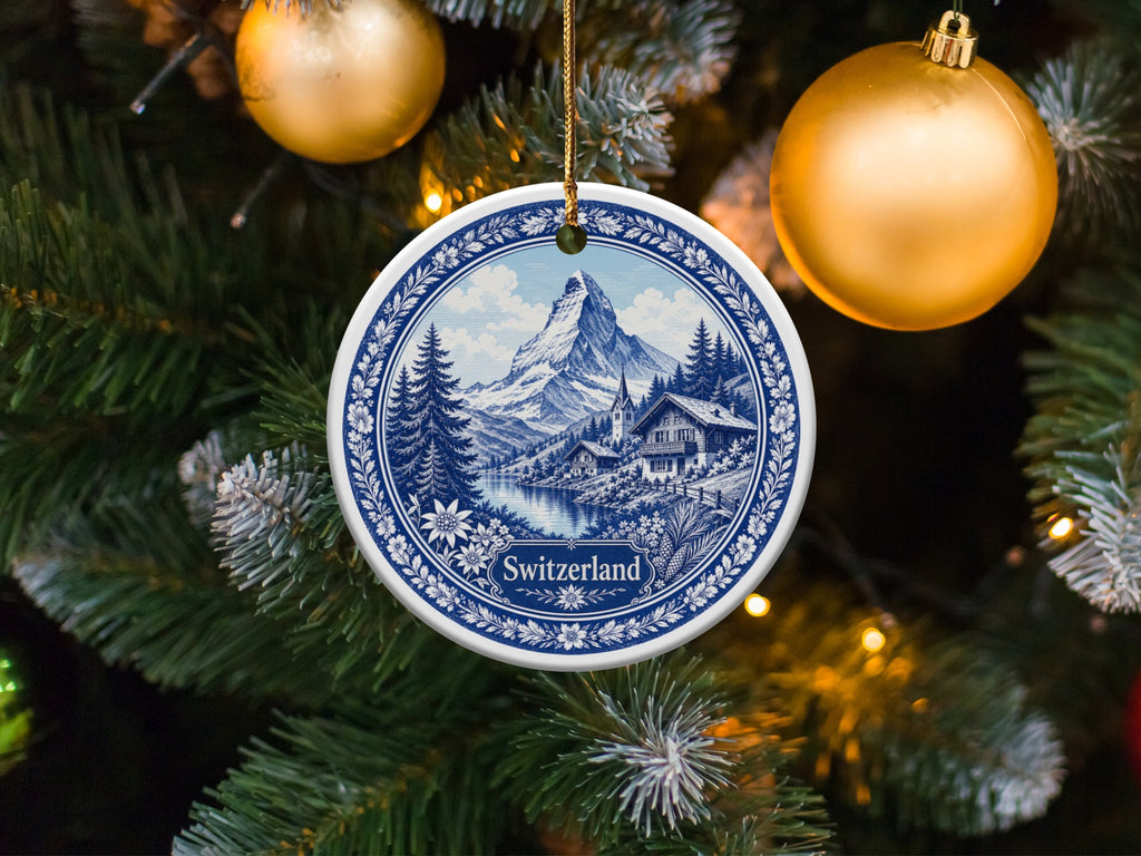 Round ornament with a blue and white Swiss mountain village scene, text "Switzerland".