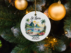 Round St. Lucia 2025 Christmas ornament depicting a beach scene with boats.
