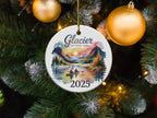 Glacier National Park ornament with couple kayaking, mountains, sunset, and "2025".