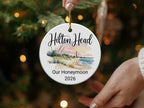 Round ornament with Hilton Head lighthouse, beach, and "Our Honeymoon 2026" text.