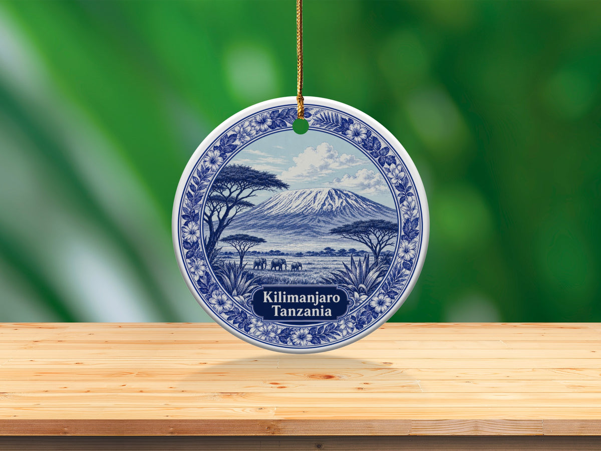 Round ornament with Kilimanjaro and elephants scene, says "Kilimanjaro Tanzania".