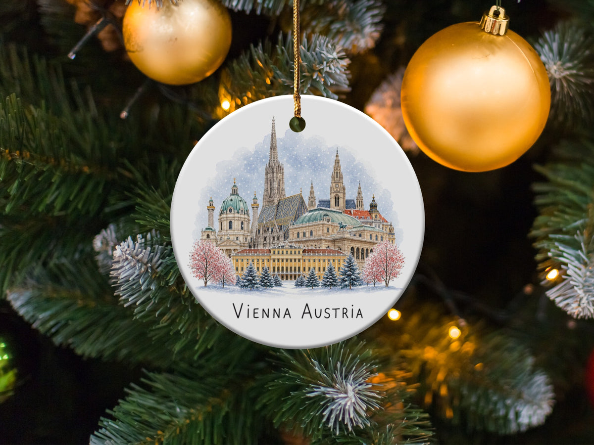Round ornament with Vienna Austria cityscape watercolor, hanging on a Christmas tree.