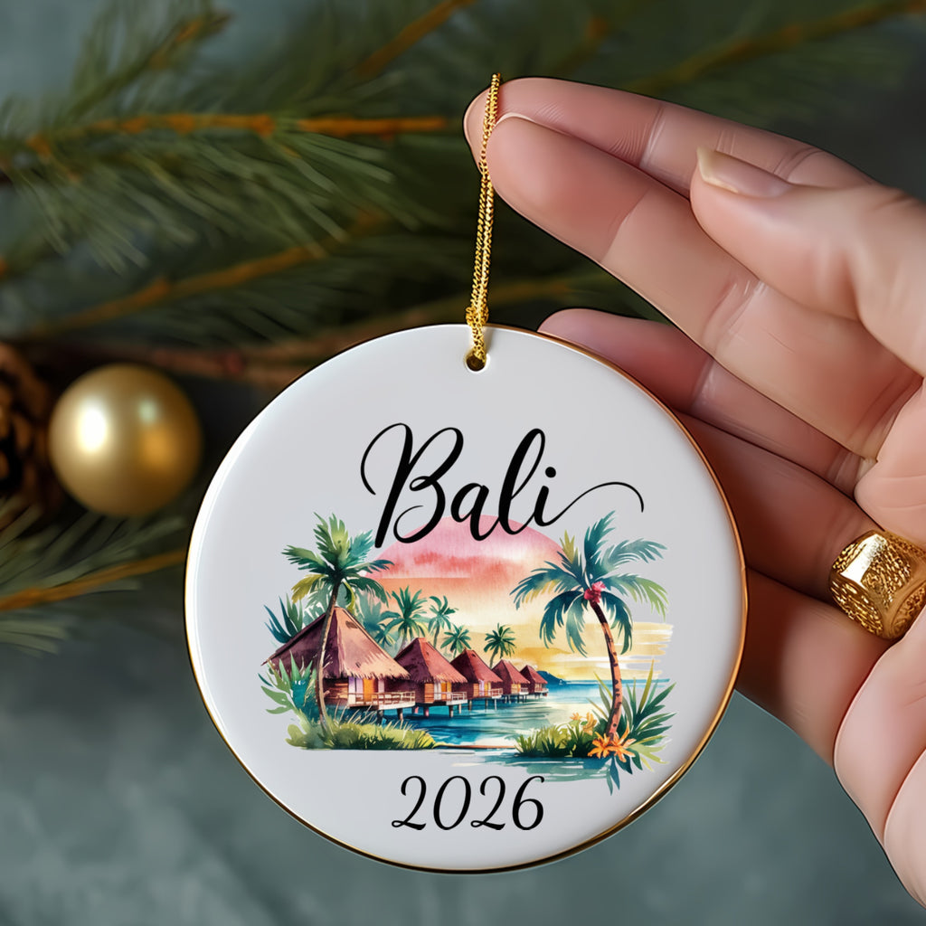 Round ornament with "Bali 2026" and tropical huts illustration.