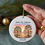 Round ornament with Joshua trees at sunset, text "Joshua Tree, California 2026".