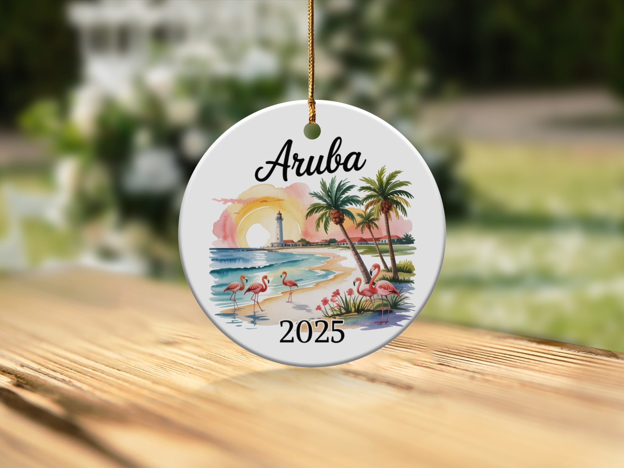 Round ornament with "Aruba 2025" text and flamingo beach scene.