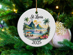 Round St. Lucia 2025 ornament with beach scene and mountains.