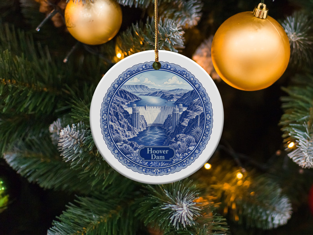 Round ceramic ornament with Hoover Dam depiction hangs on Christmas tree.