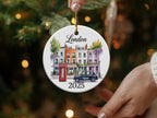 Round London ornament with buildings, phone booth, and car, dated 2025.