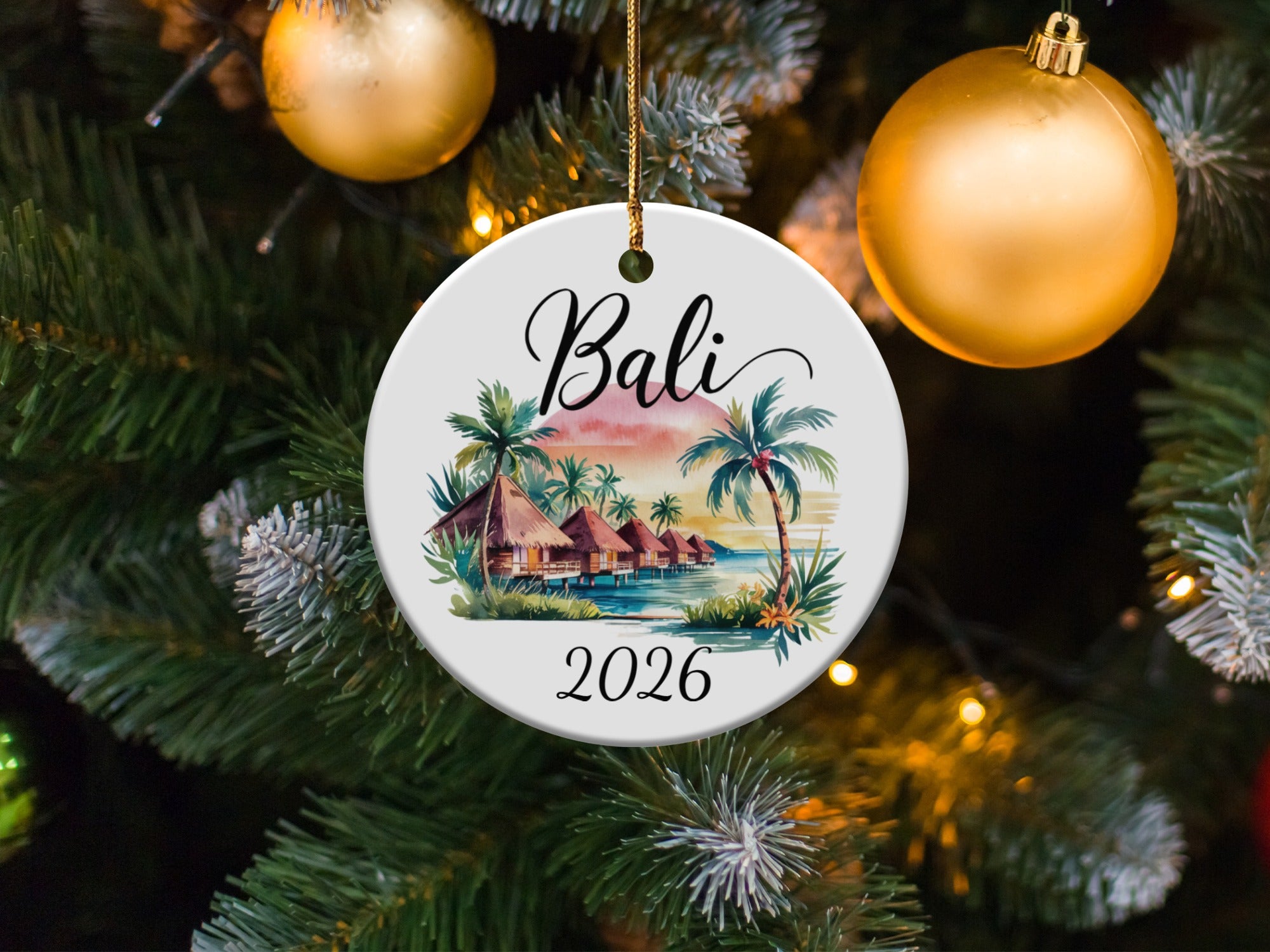 Round ornament with tropical beach scene, palm trees, and "Bali 2026" text.