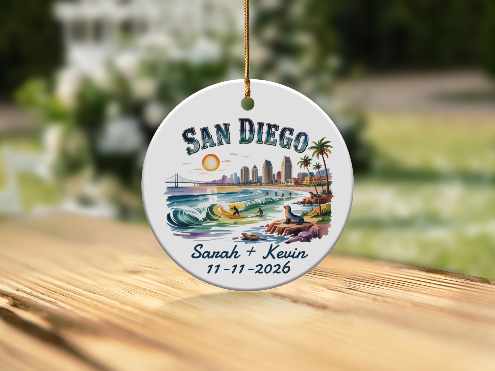 San Diego skyline ornament with waves, surfers, seals, and personalized names and date.