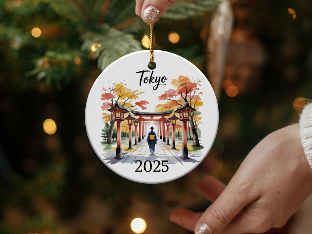 Round ornament with "Tokyo 2025" and shrine gate design.