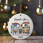 Round ornament with a watercolor scene of Carmel-by-the-Sea shops, dated 2025.