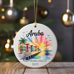 Round Christmas ornament with Aruba scene and "Our Honeymoon 2025" text.