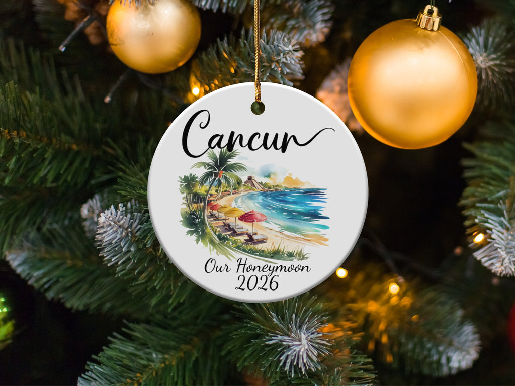 Round ornament with beach scene and text "Cancun Our Honeymoon 2026".