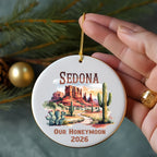 Round ornament with Sedona landscape, cactus, and "Our Honeymoon 2026" text.