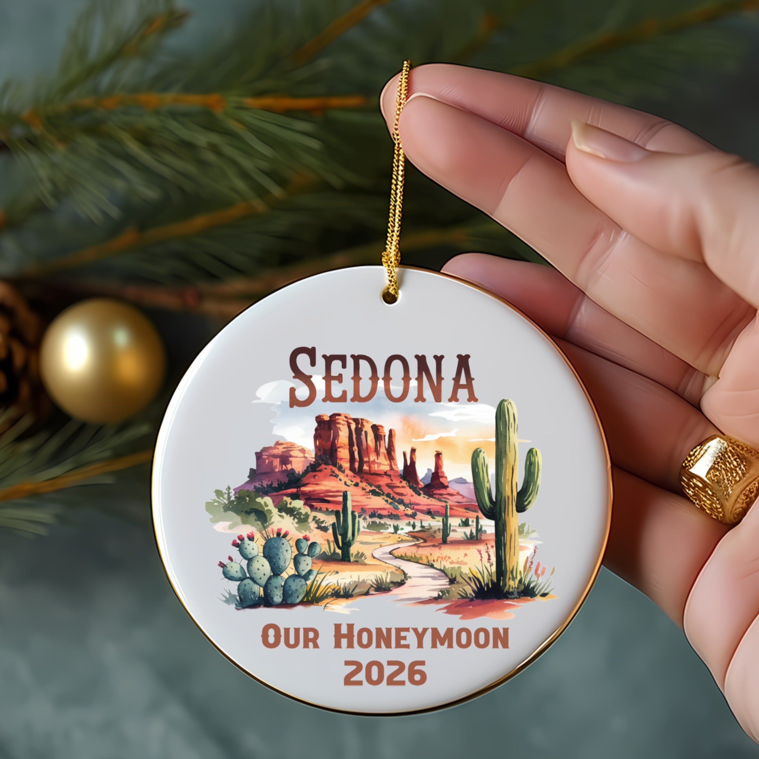 Round ornament with Sedona landscape, cactus, and "Our Honeymoon 2026" text.