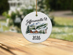 Round ceramic ornament with "Jeffersonville VT 2026" and a ski resort scene.