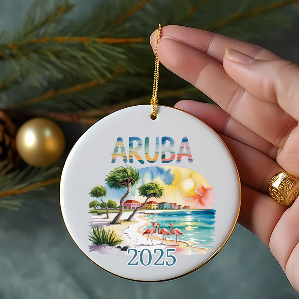Round ornament with "ARUBA 2025" text, palm trees, and flamingos on beach.
