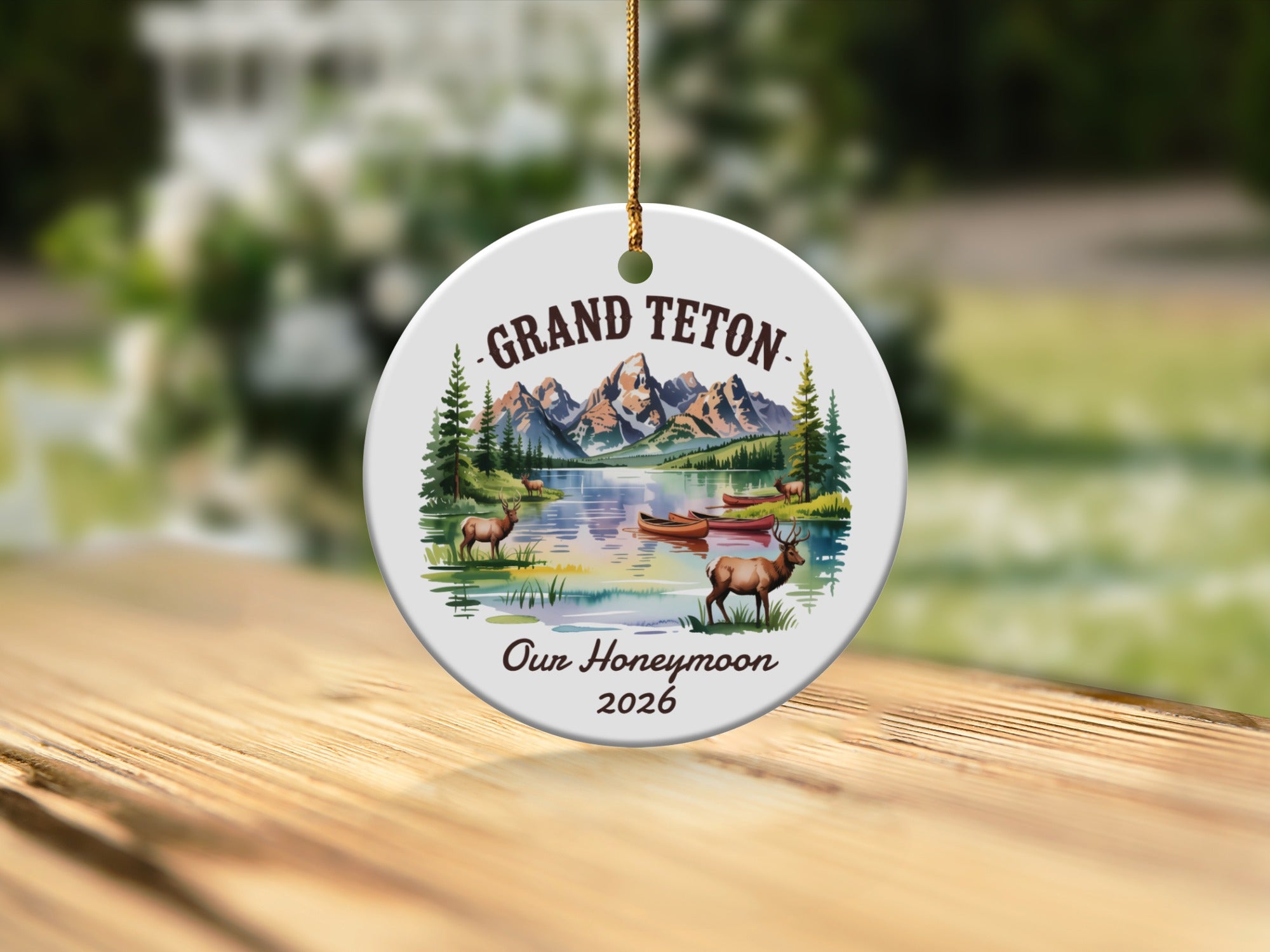 Grand Teton Our Honeymoon 2026 circular ornament with mountains, lake, deer, and canoe.
