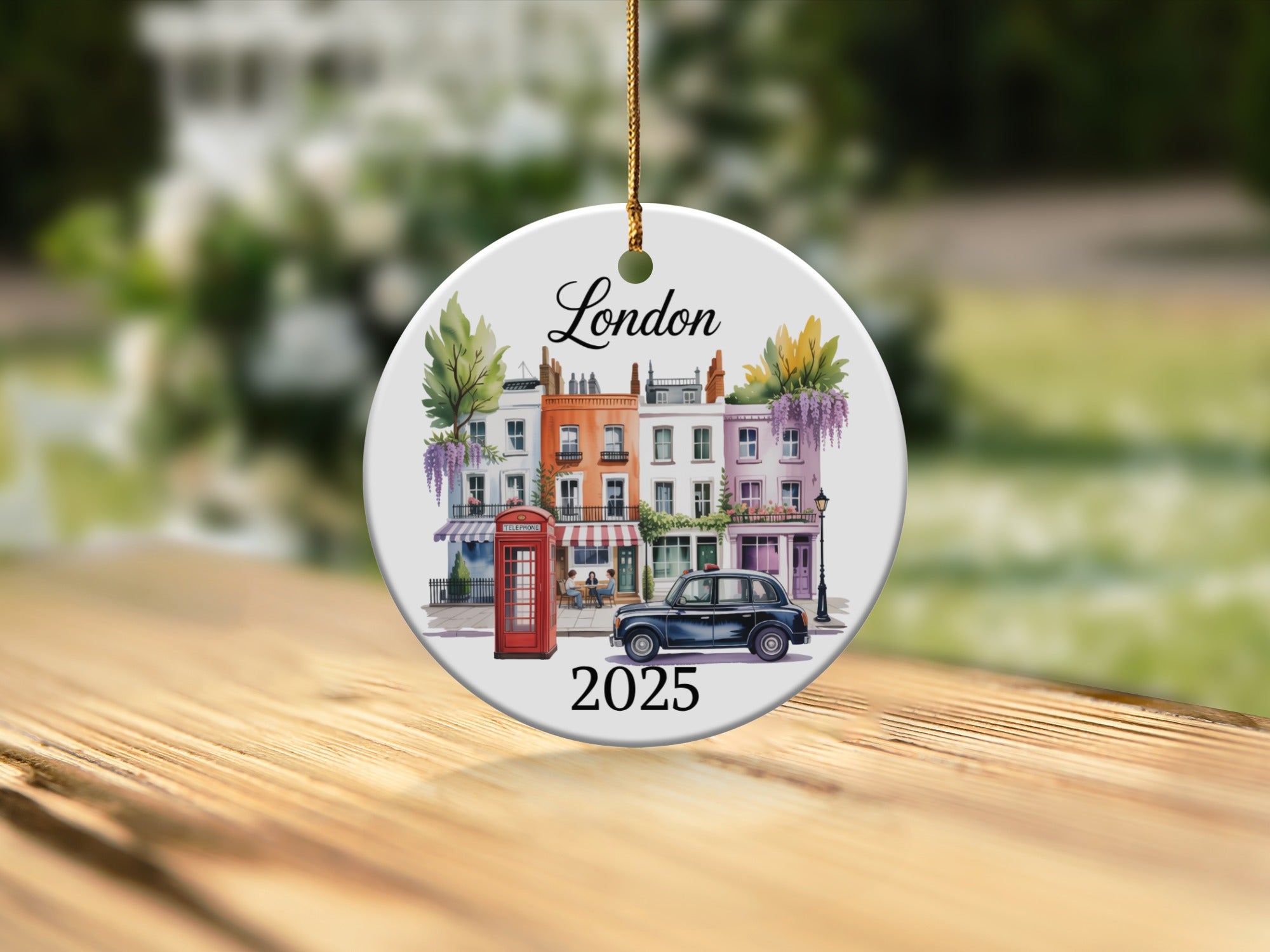 Ceramic ornament depicting London row houses, red phone booth, and car, with "London 2025" text.
