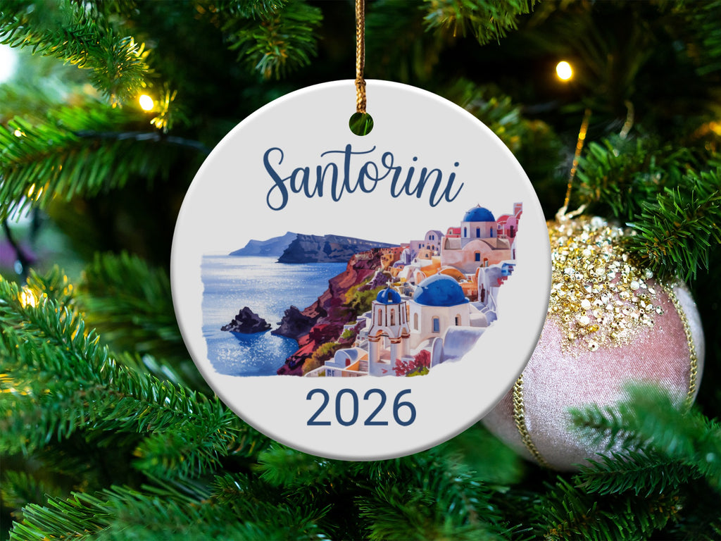 Santorini 2026 ornament with white buildings and blue domes on a cliffside.