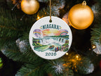 Niagara Falls 2026 ceramic ornament with colorful illustration hanging on a Christmas tree.