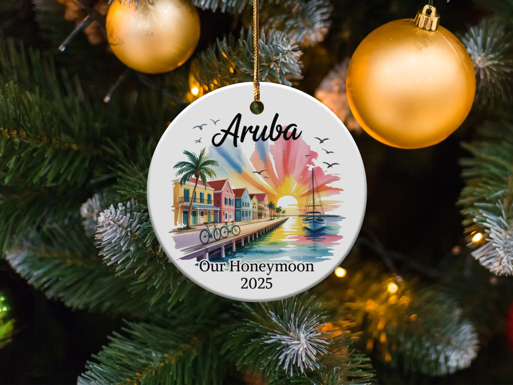 Aruba honeymoon ornament with sailboat and colorful buildings at sunset.