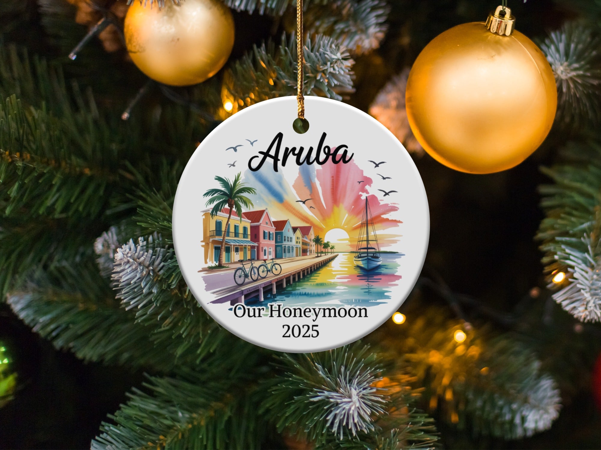 Aruba honeymoon ornament with sailboat and colorful buildings at sunset.