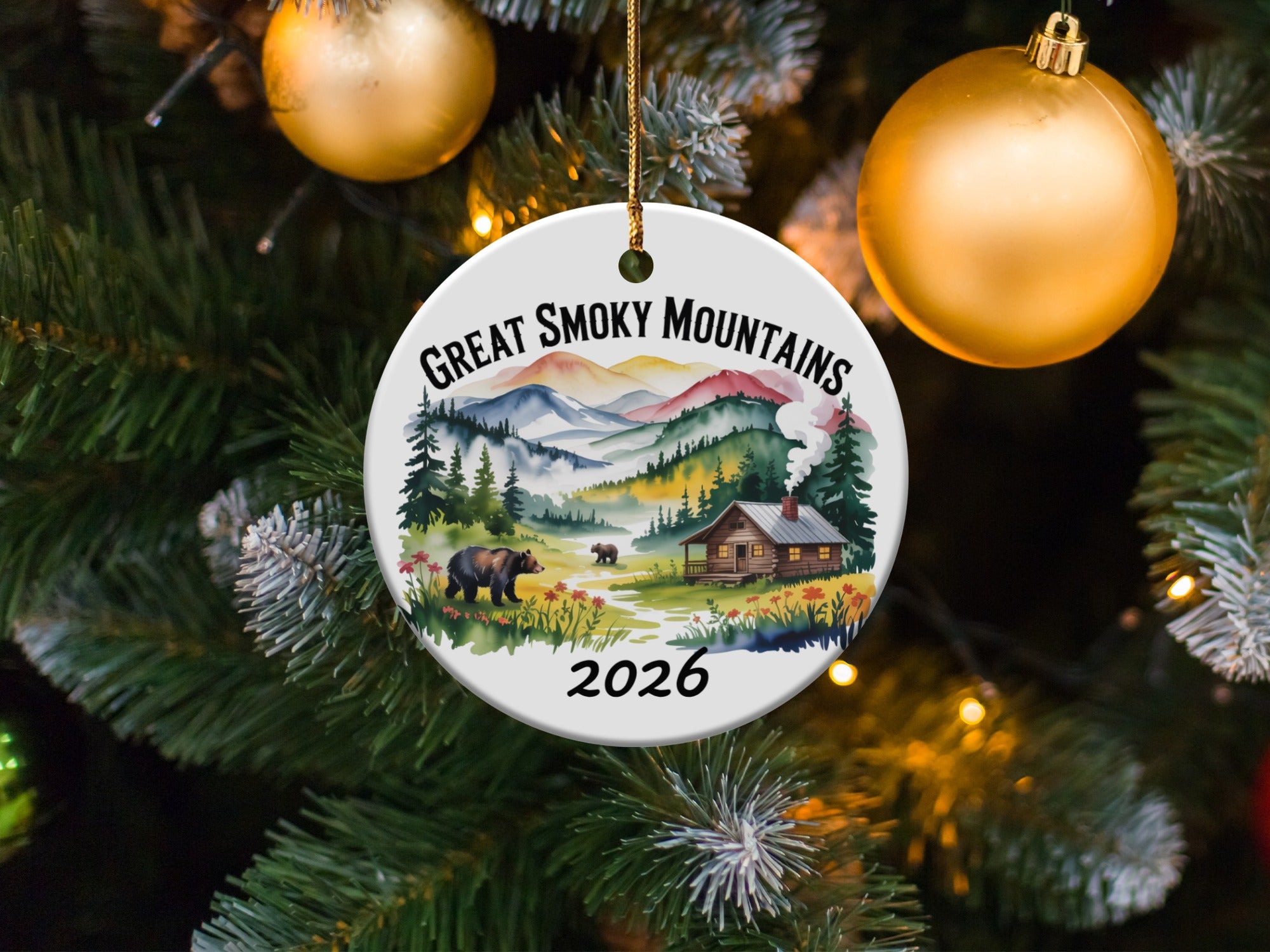Great Smoky Mountains 2026 ornament with cabin and bears on a tree.